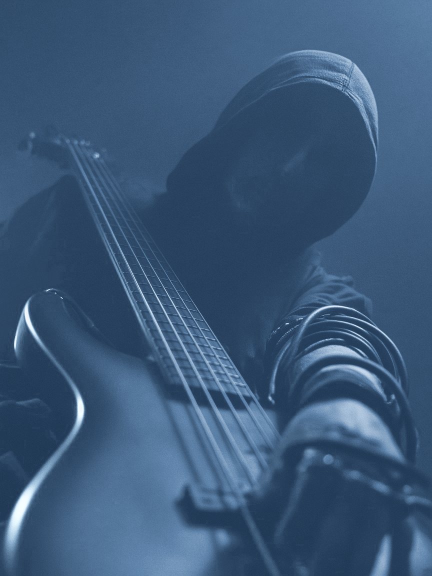 ohm with a bass guitar, face hidden under a hood